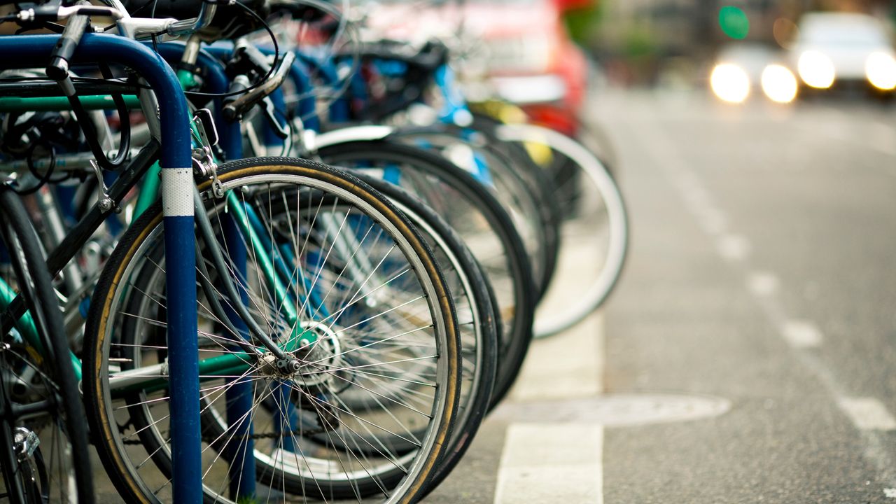 bikes locked up next to a road