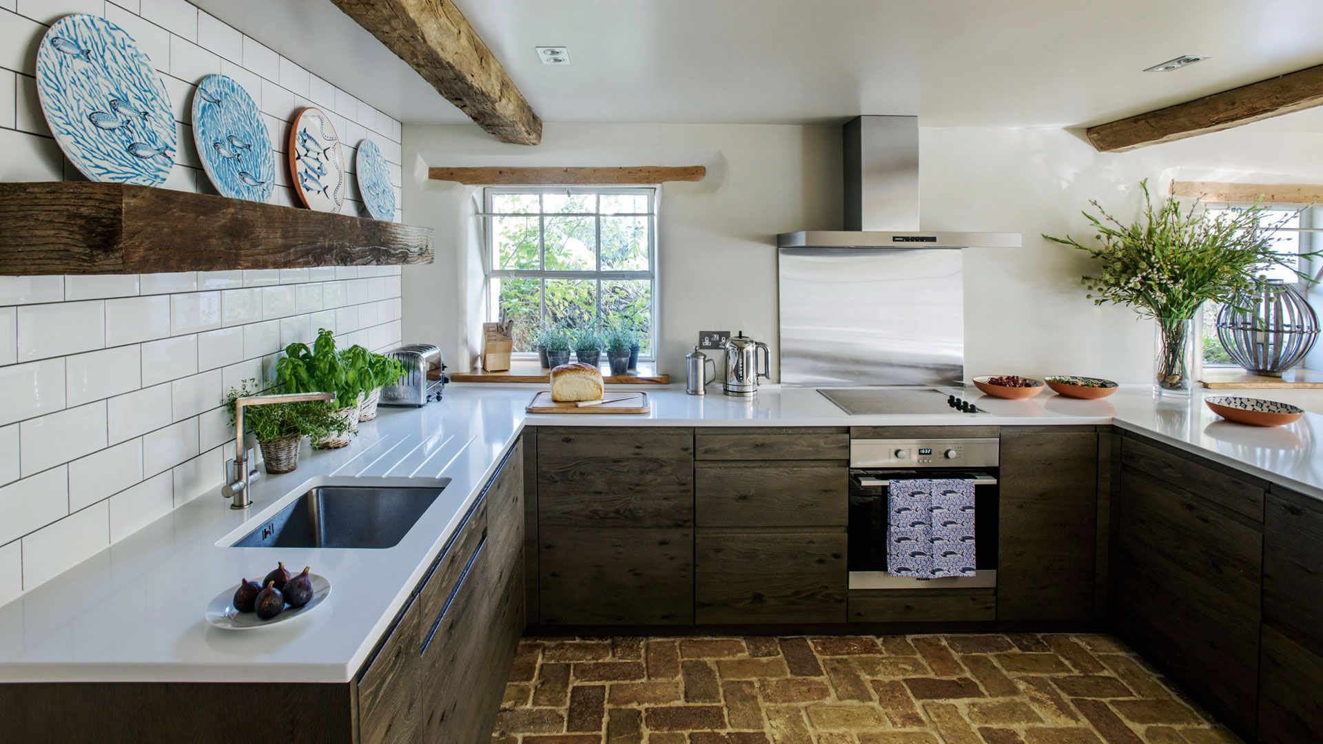 Organizing kitchen countertops in rustic kitchen with wooden cabinets and white marble clean countertops