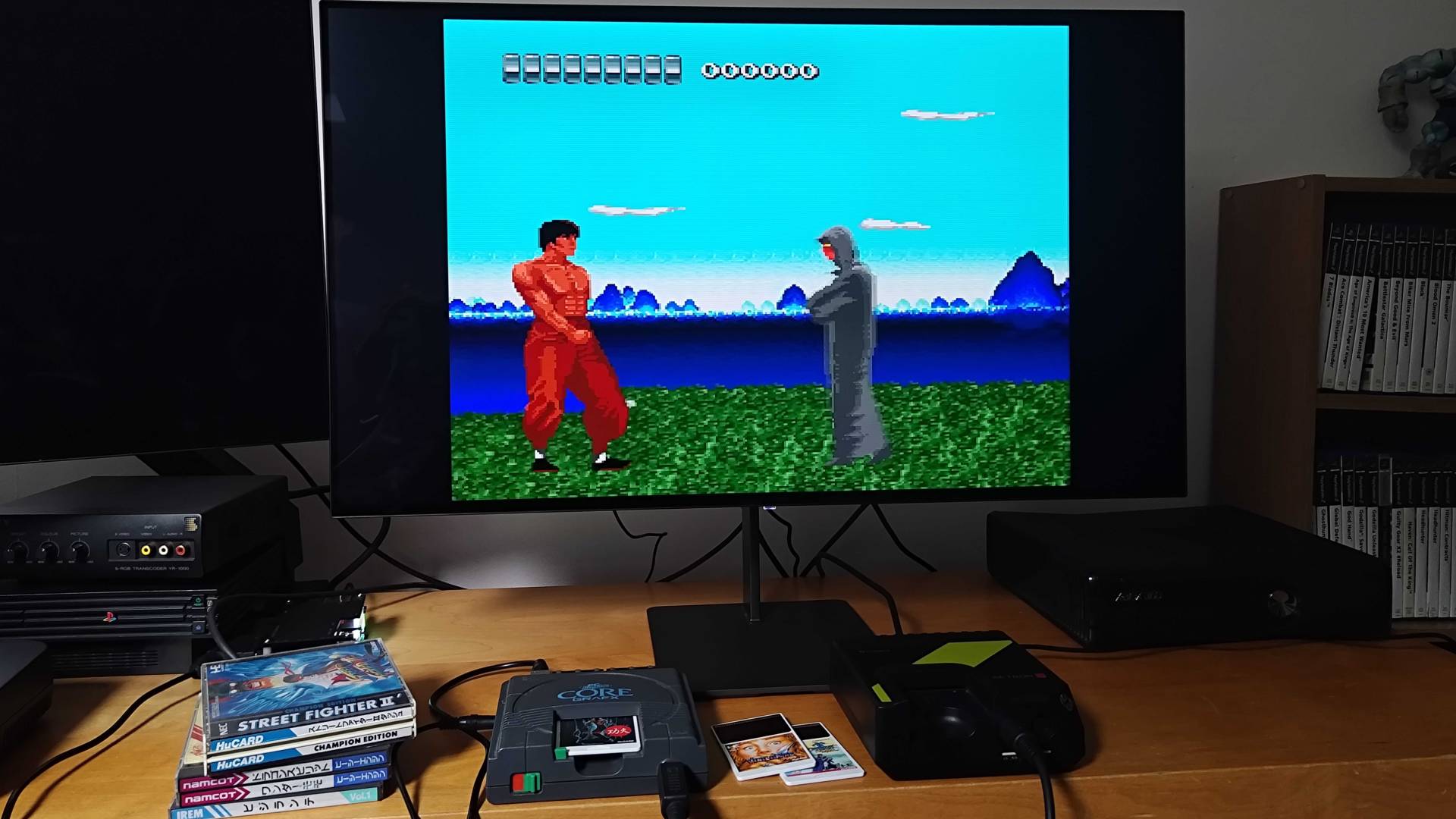 PC Engine running The Kung Fu next to Hyperkin Retron GX beneath monitor.