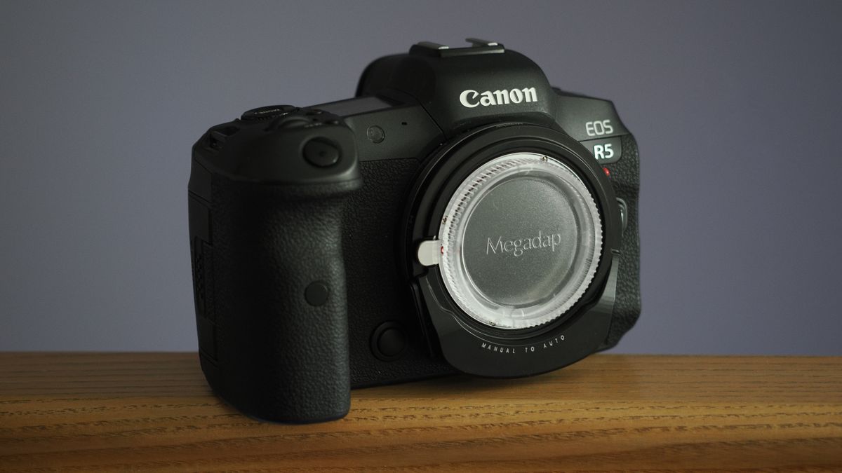 Megadap M2RF adapter mounted to a Canon EOS R5 on a wooden surface