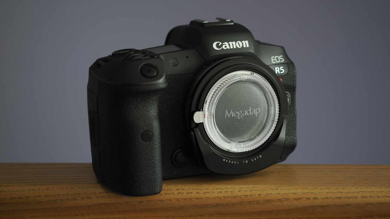 Megadap M2RF adapter mounted to a Canon EOS R5 on a wooden surface