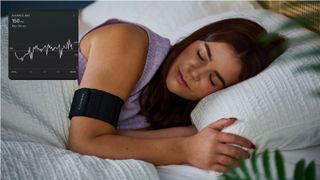 Our sleep tech tester wearing the Garmin Index Sleep Monitor armband sleeping on side in bed with white sheets with inset of HRV graph