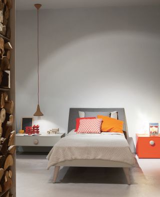 how to design a kid's room: kids bedroom with white scheme and single bed and colourful bedding by go modern furniture