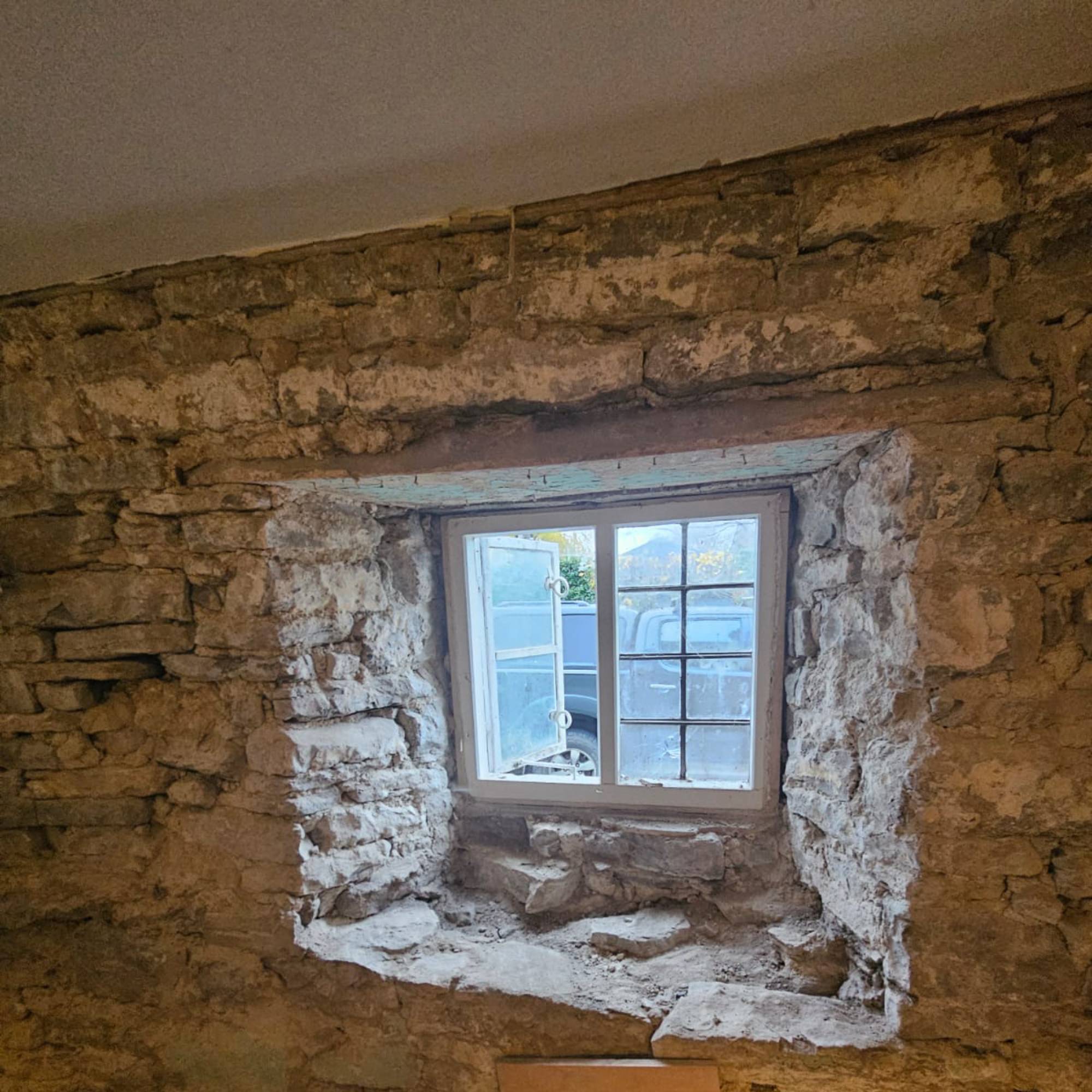 timber window surrounded by stone walls