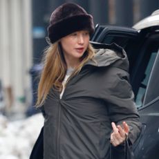 Jennifer Lawrence was spotted in NYC wearing a parka, a fur hat, a vintage Dior Galliano bag, and Ugg boots