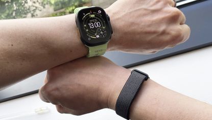 Apple Watch Ultra 3 and Google Fitbit Air being worn on wrists