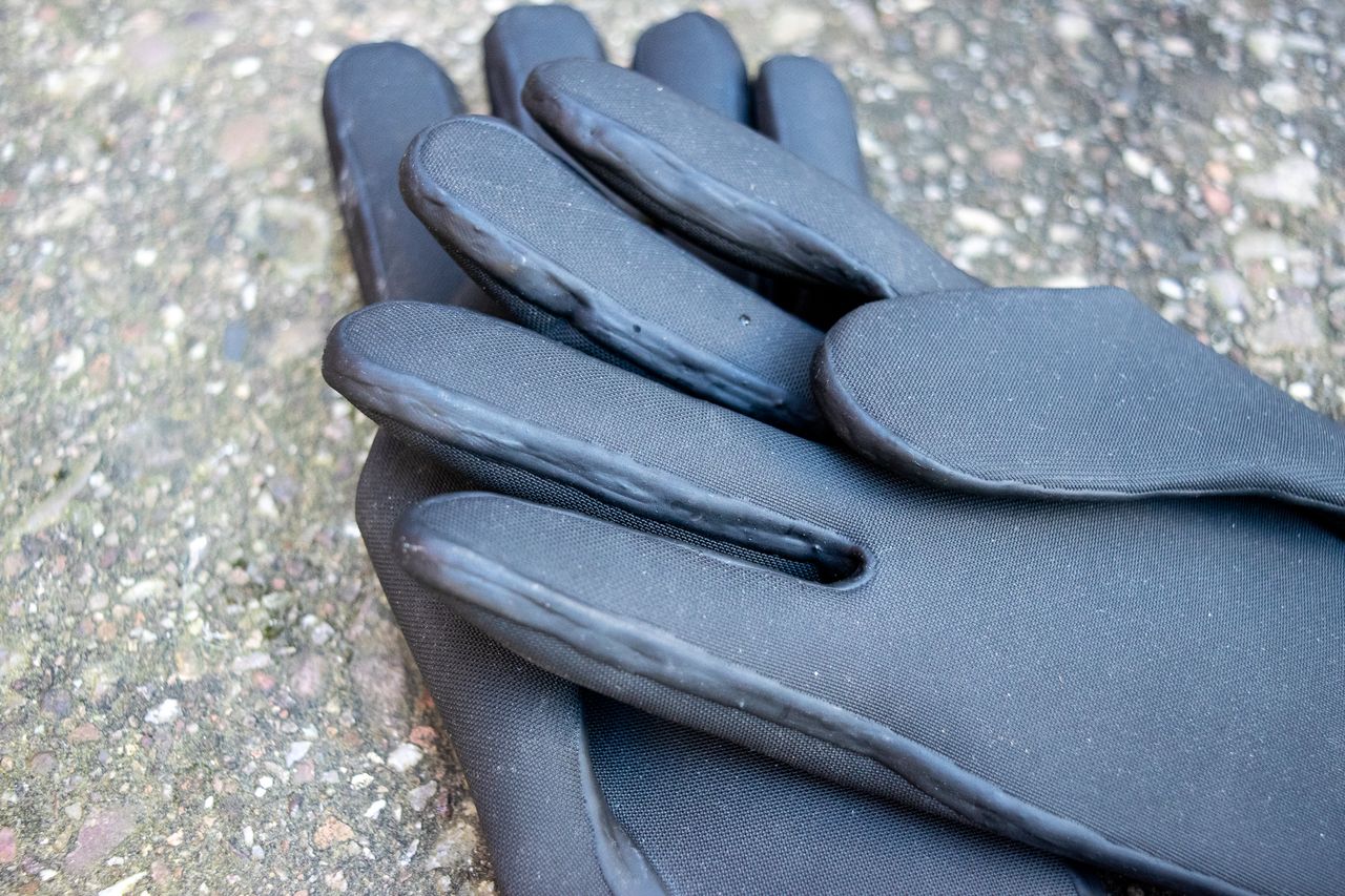 Black Velotoze neoprene gloves on some concrete