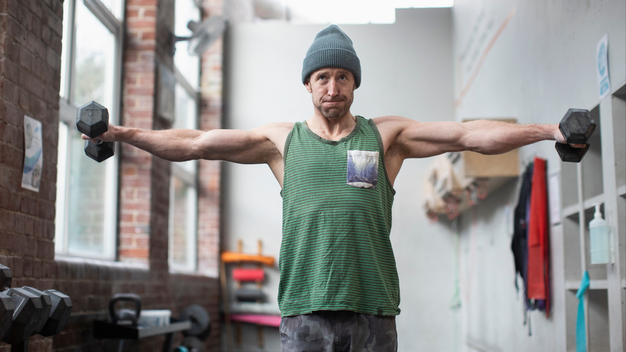 Man performing Poliquin raises in his home