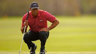 Tiger Woods reads a putt