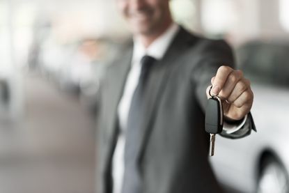 A man holds car keys.