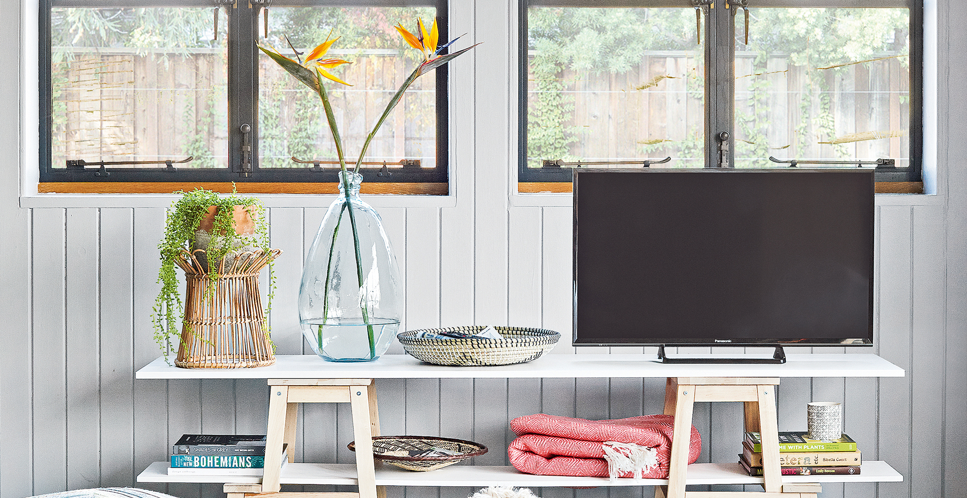 pale grey living room with a flatscreen TV on a trestle table