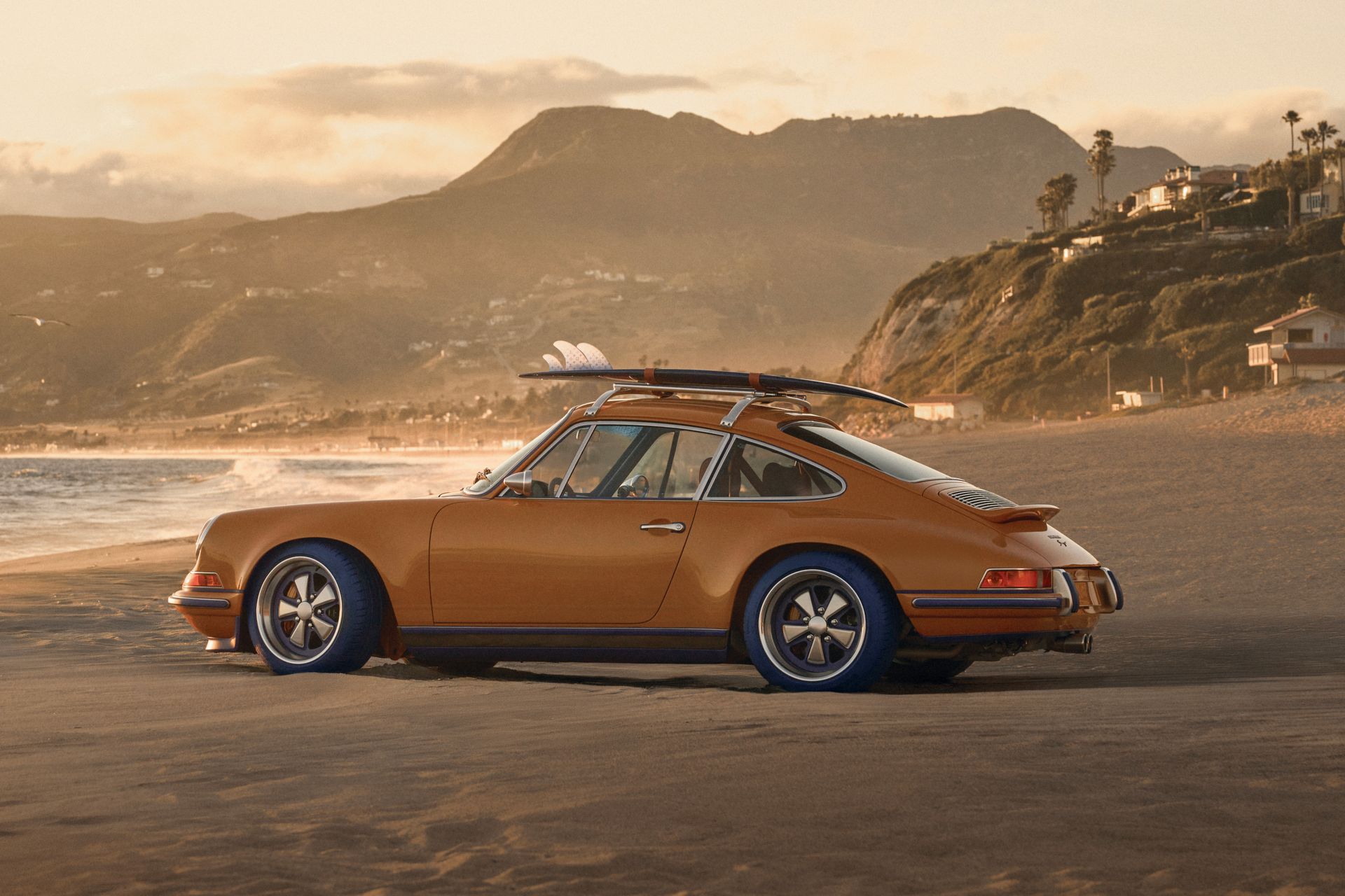 Porsche 911 Reimagined by Singer x Louis Vuitton, on beach with surfboard on roof
