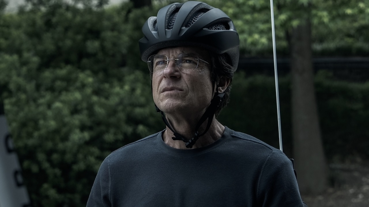 Clark wearing bike helmet sitting in recumbent bike in DTF St. Louis