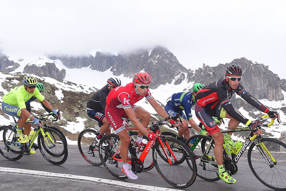 The peloton climbs into the snow line climbs during stage 5 at Tour de Suisse