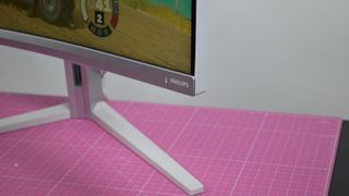 A Philips Evnia 34m2c7600mv on a desk playing a racing game