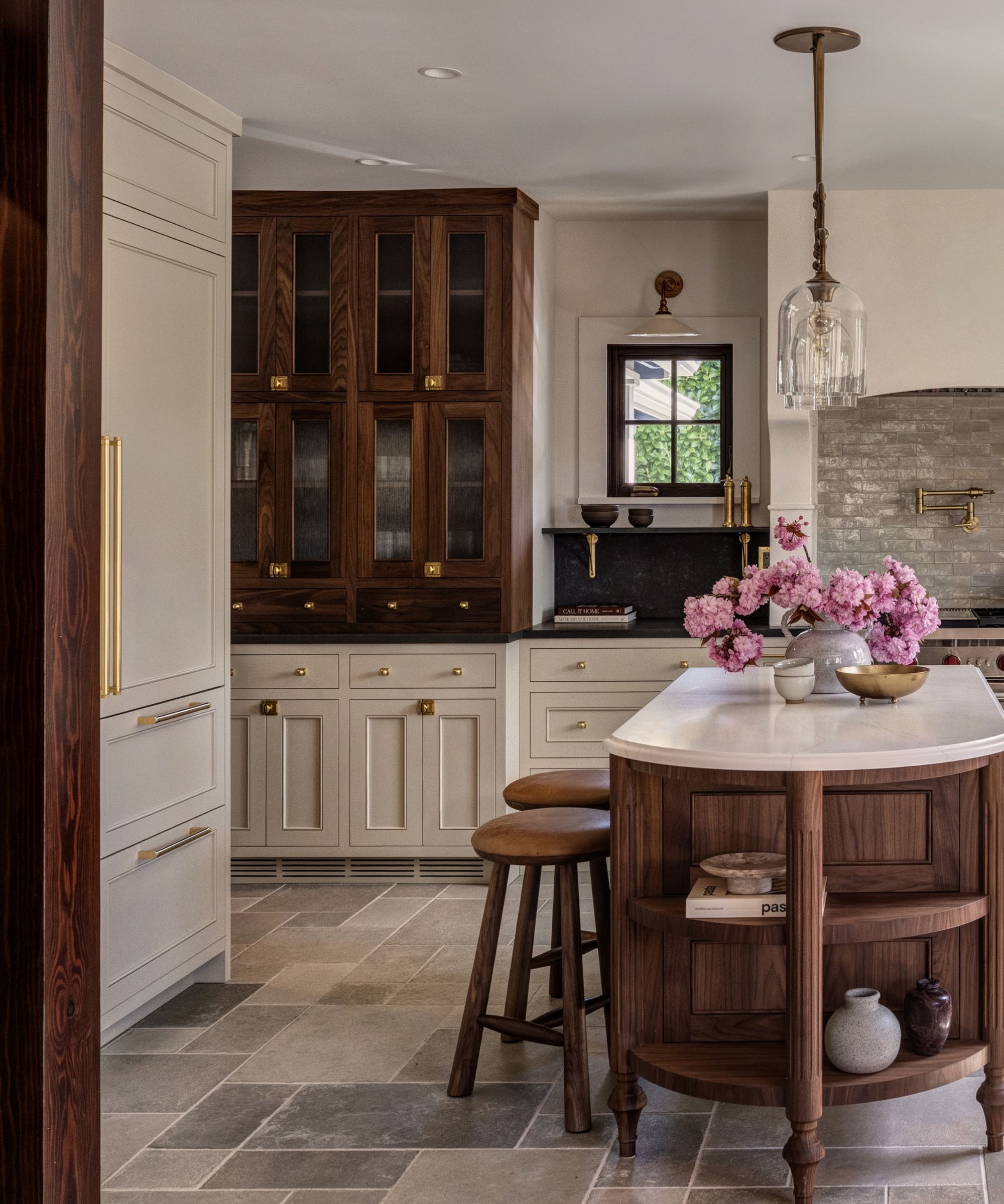 A wood and white kitchen with wood upper glazed cabinets