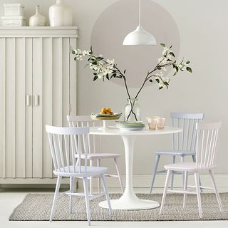 dining area with white wall and dining table