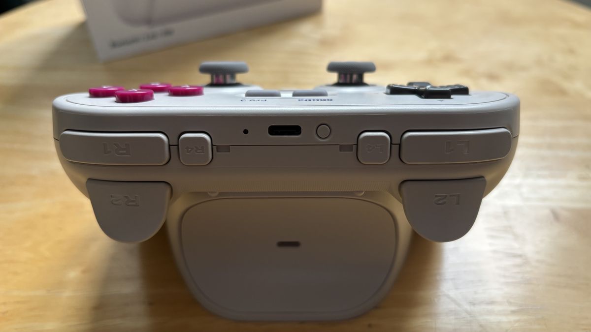 The 8BitDo Pro 3 controller photographed on a wooden table.
