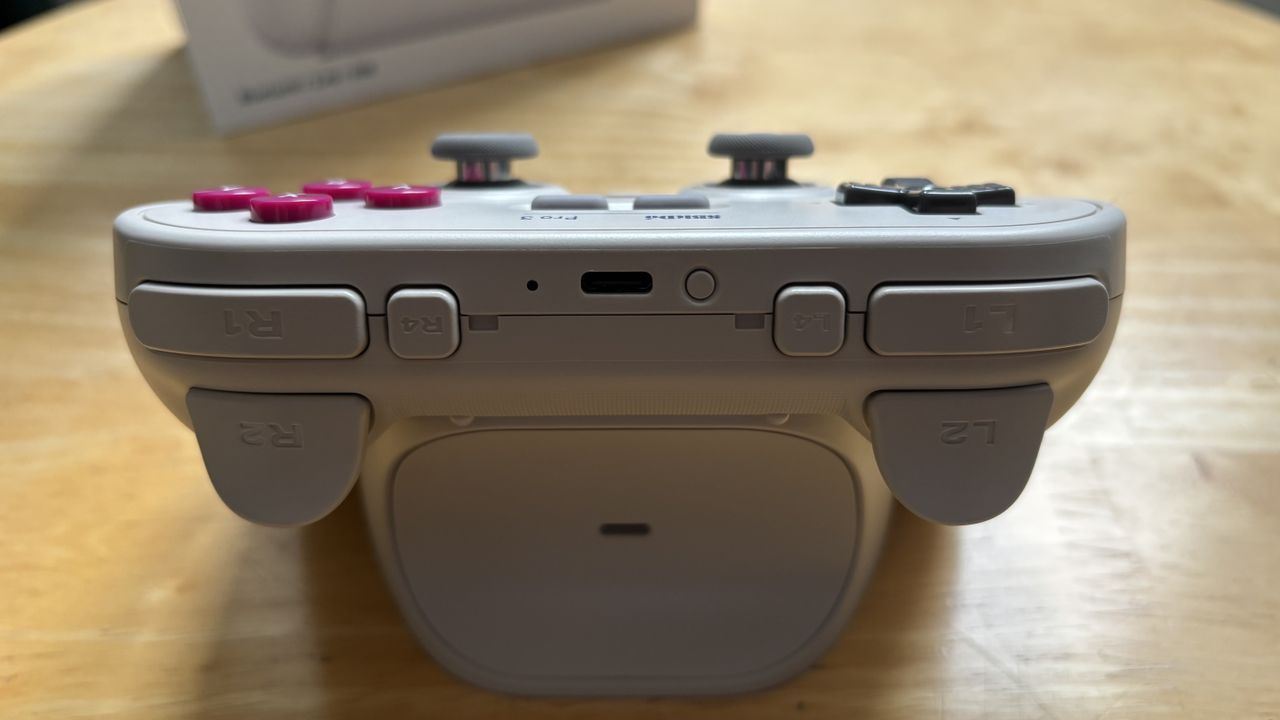 The 8BitDo Pro 3 controller photographed on a wooden table.