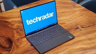 Dell XPS 13 Plus im matten Kohle-Look auf einem Holztisch