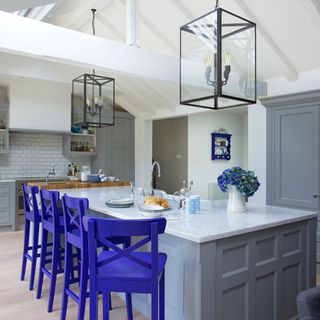 kitchen with blue bar tool chair and grey counter