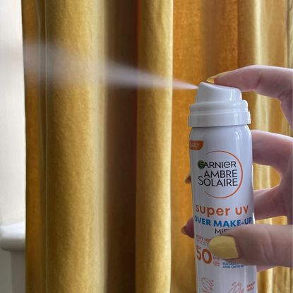 valeza spraying the garnier super uv over make-up mist