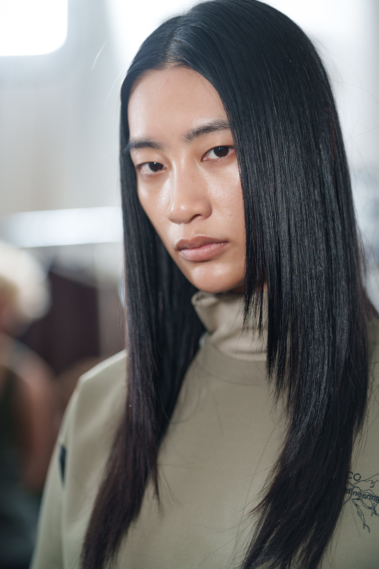 A model with their hair cut into a butterfly cut.