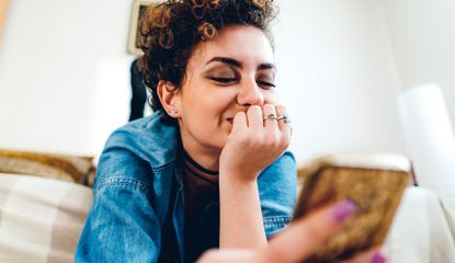 Woman smiling at her phone