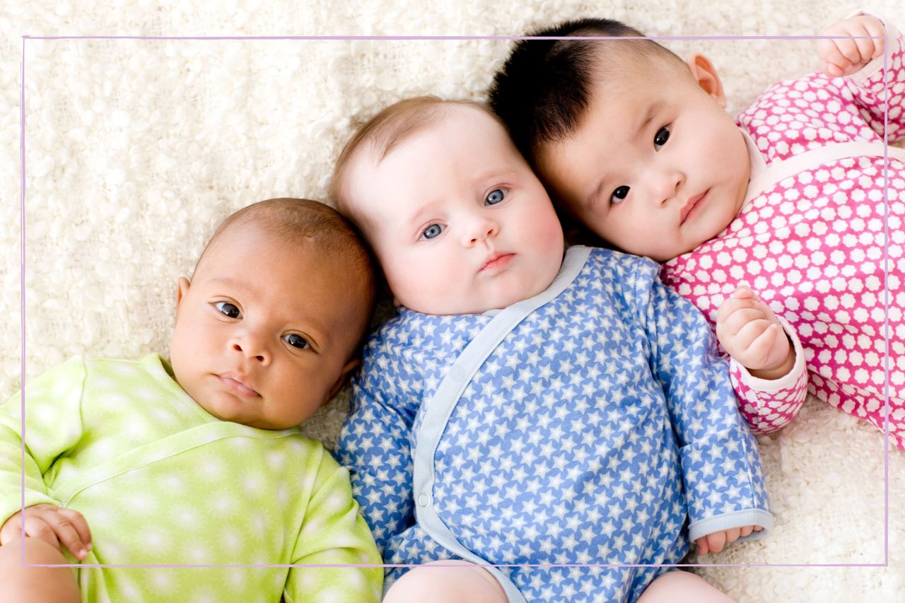 Three babies lying on their back looking at the camera