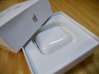 The AirPods case rests in its box.