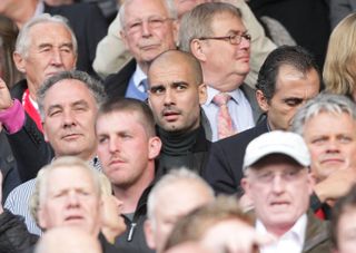 Barcelona coach Pep Guardiola (centre) watches Manchester United vs Schalke in the 2011 Champions League semi-finals.