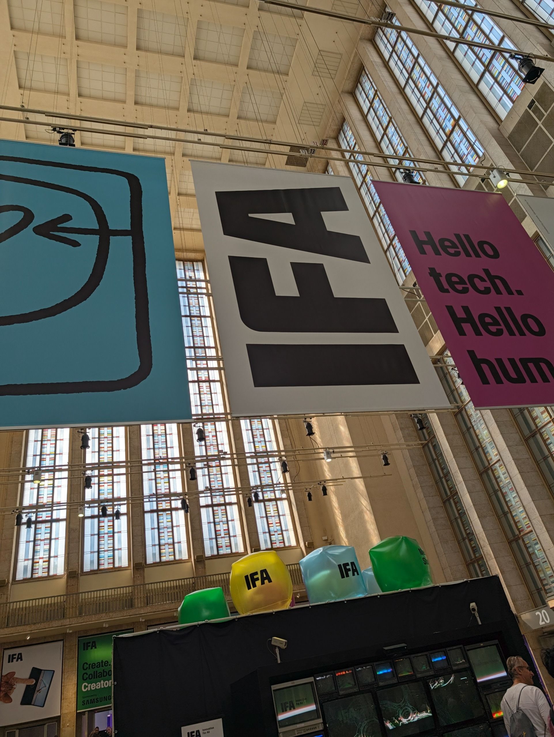 Large IFA exhibition banners hanging inside a high-ceilinged event hall.