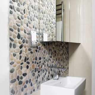 Pebble wall covering in small shower room