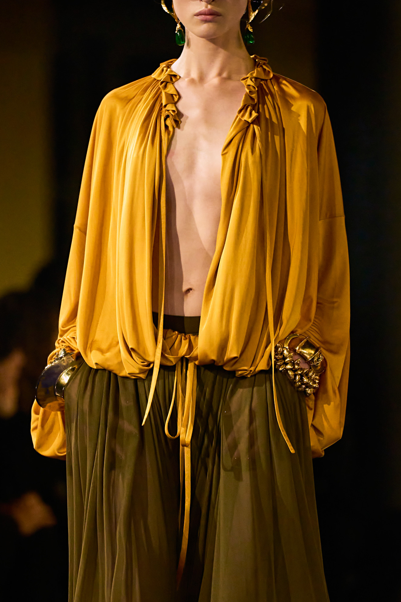 A model wore turmeric yellow on the Saint Laurent Spring 2025 runway