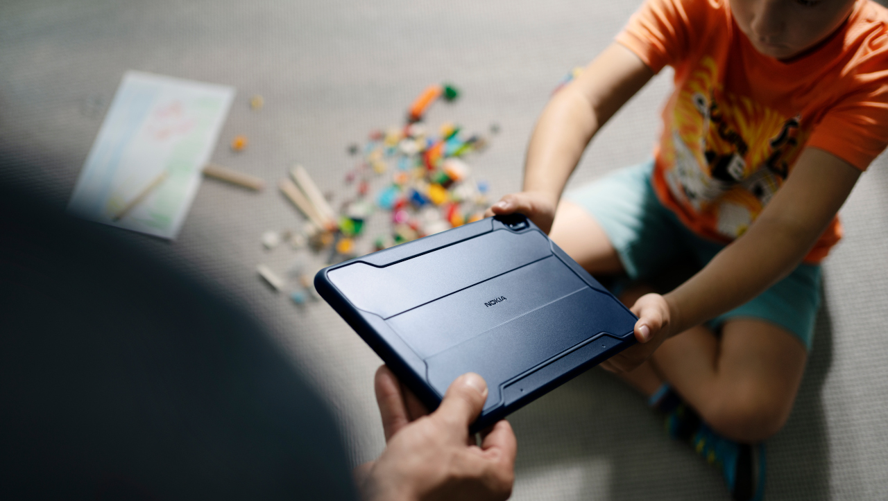 Parent handing tablet to child
