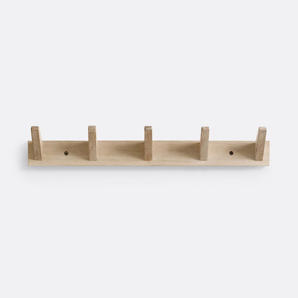 A minimalist wall-mounted oak coat rack with five evenly spaced square wooden pegs projecting upward from a flat horizontal rail. The piece is natural light oak in finish, secured with two visible screws, and photographed against a plain white background.