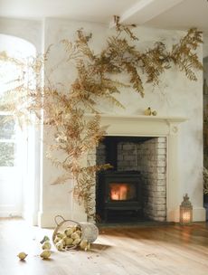 fall flower and foliage display around a mantle