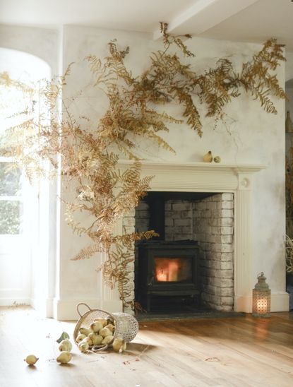 fall flower and foliage display around a mantle