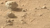 a large stone is cracked in such a way as to appear like three stones stacked on one another