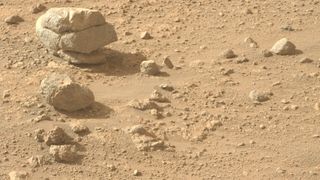a large stone is cracked in such a way as to appear like three stones stacked on one another