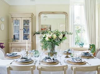 neutral dining room with a fresh winter bouquet