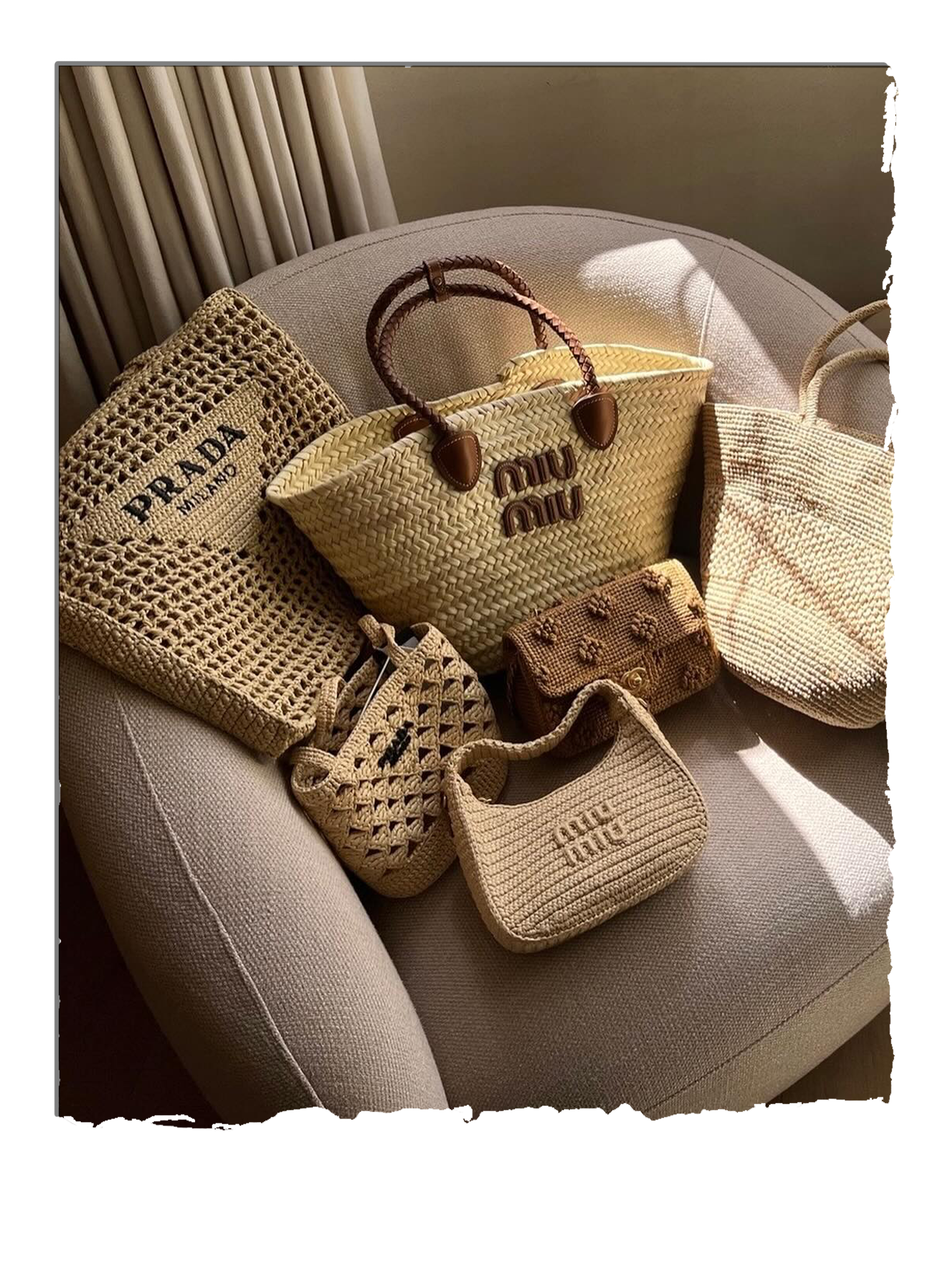 A selection of designer basket bags sit on top of a pink armchair