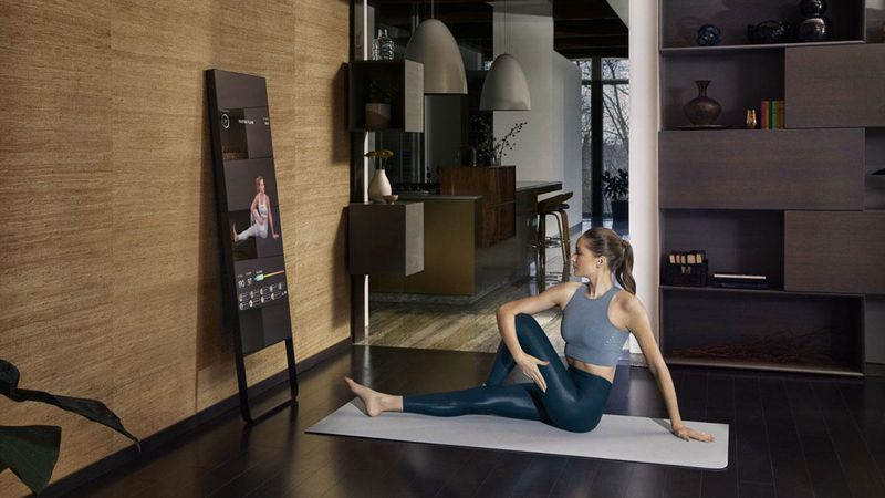 A woman working out in front of Mirror at home