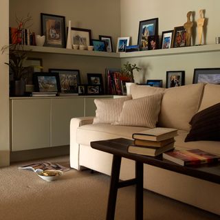 living room with photoframes on shelves on wall