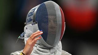 France's Sara Balzer competes, with nails blue, white and red, to the colours of the French flag, against Turkey's Nisanur Erbil in the women's sabre individual round of 16 bout during the Paris 2024 Olympic Games at the Grand Palais in Paris, on July 29, 2024.