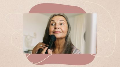 Landscape image of woman applying makeup set in front of fine line illustrations and an abstract pink shape on a beige background