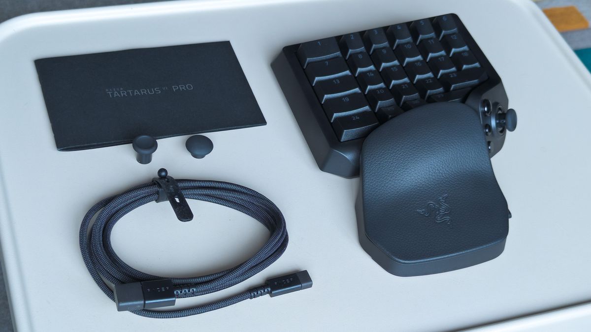 Razer Tartarus V2 Pro box contents displayed on a metal table