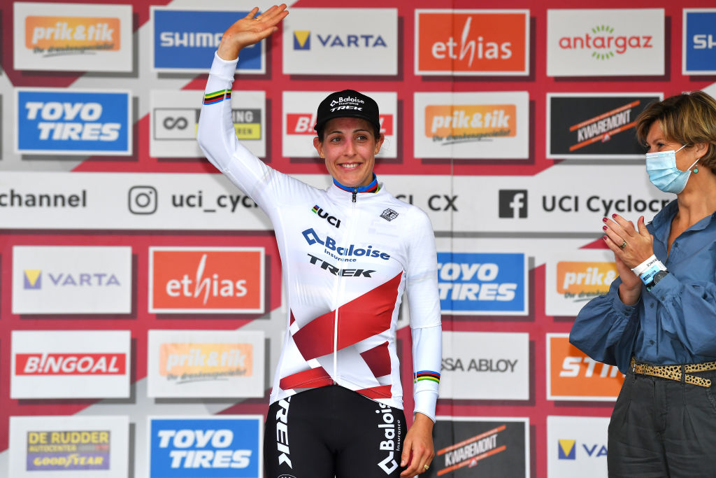 OVERIJSE BELGIUM OCTOBER 31 Lucinda Brand of The Netherlands and Team Baloise Trek Lions puts on White UCI CycloCross Worldcup Jersey on the podium ceremony after the 62nd Druivencross Overijse UCI CycloCross Worldcup 2021 Womens Elite DruivencrossOverijse CXWorldCup UCIcyclocrossWC on October 31 2021 in Overijse Belgium Photo by Luc ClaessenGetty Images