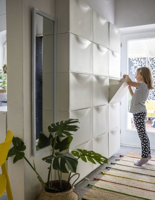 IKEA organization ideas for small spaces with a wall of Trones shoe cabinets in a narrow small hallway