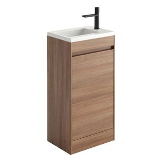 A slimline bathroom vanity unit with a compact basin and faux wood finish